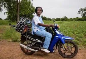 Team member on motor bike delivering to rural areas
