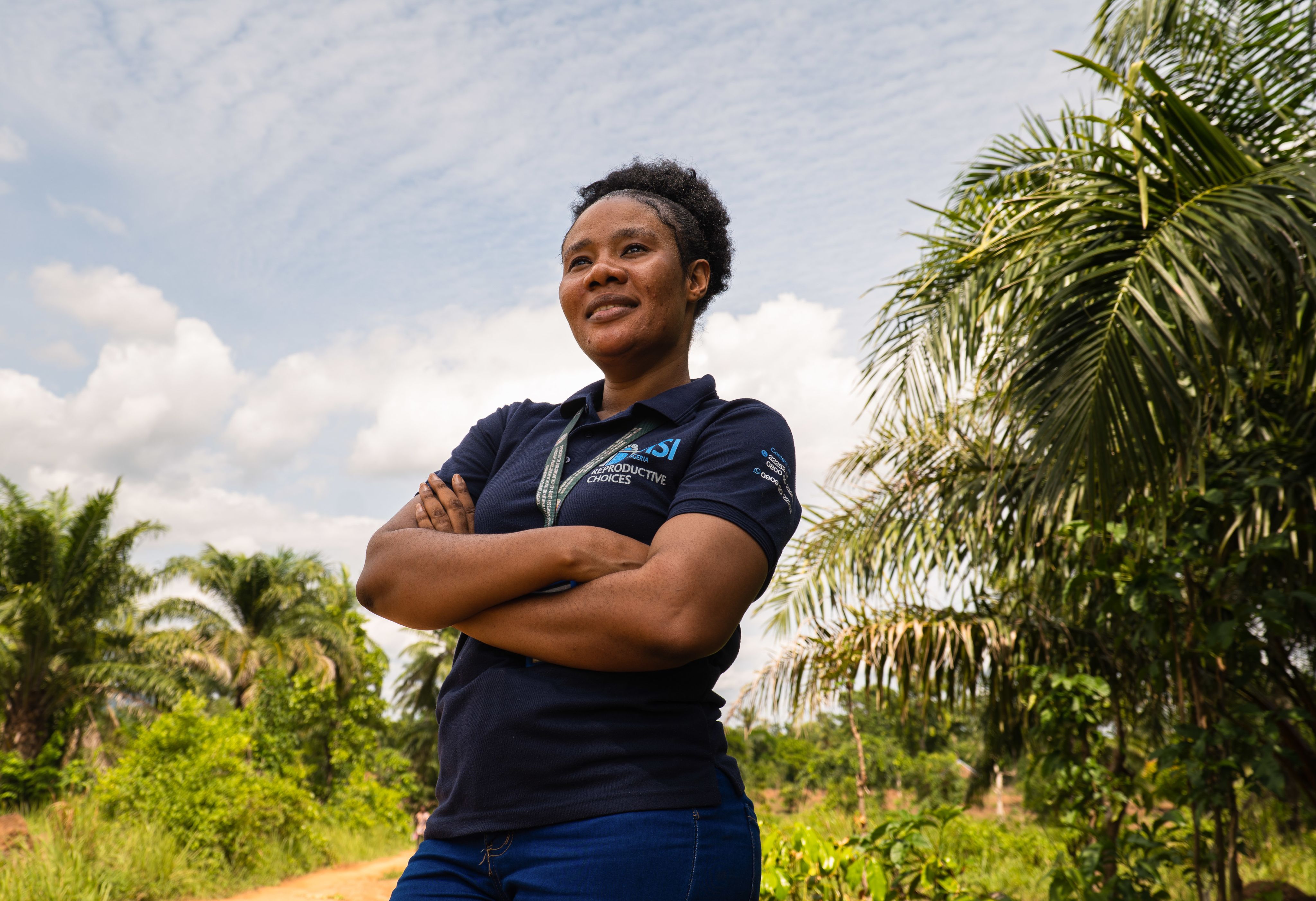 MSI nurse Ify looks proudly into the distance with her arms crossed
