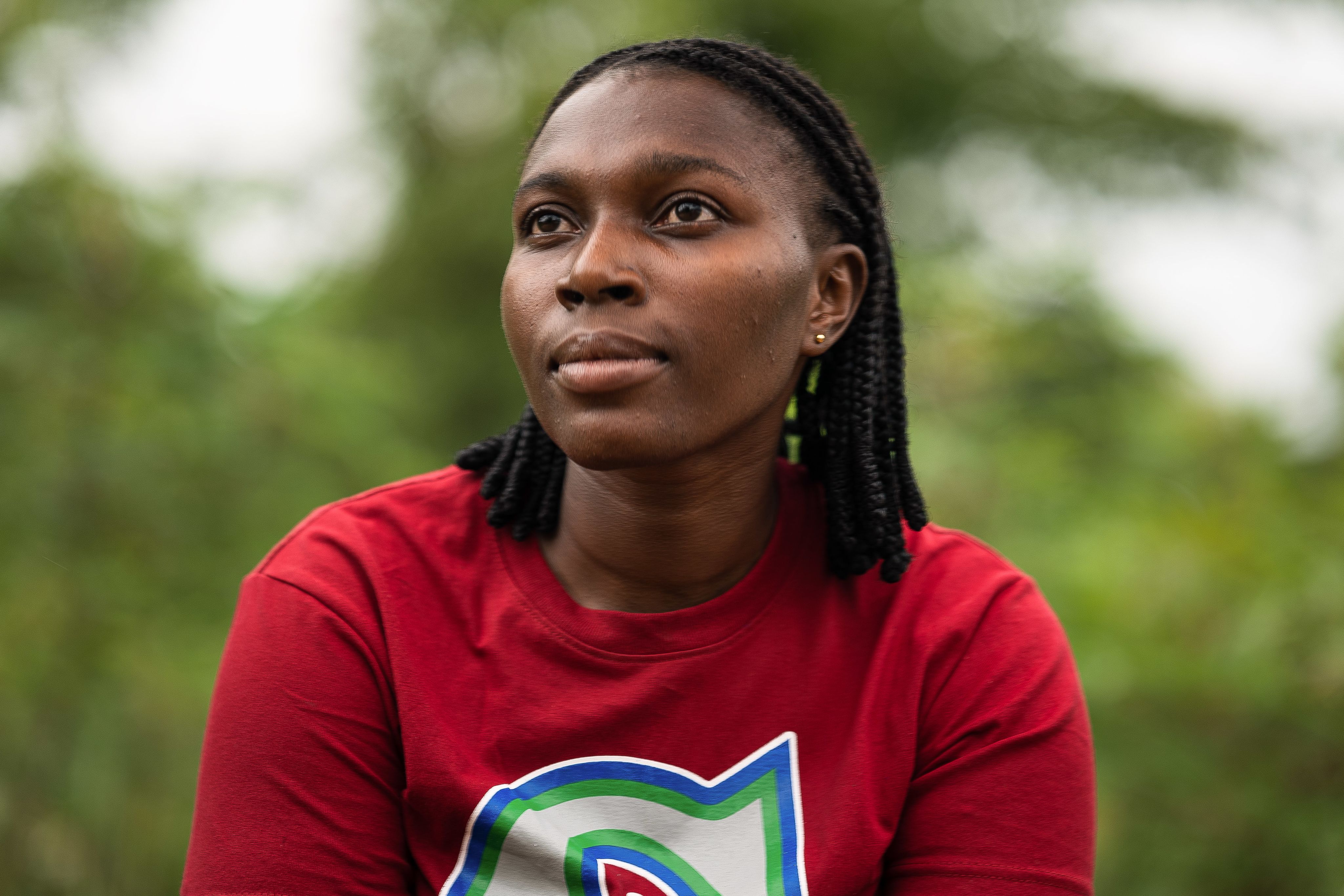 Close up of MSI client Adadechei's face as she looks into the distance